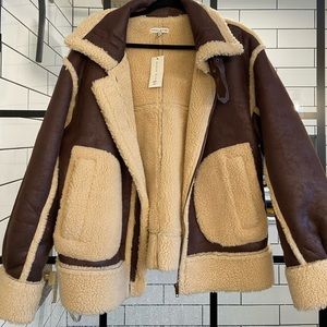 Amazing bomber jacket.  Leather & Sherpa with belted details.